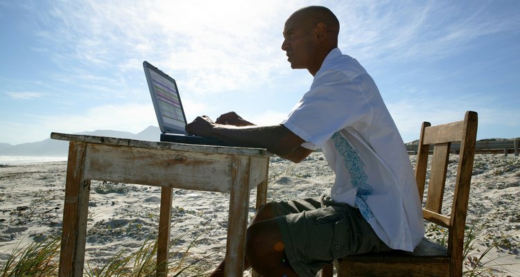 Man working at desk on beach