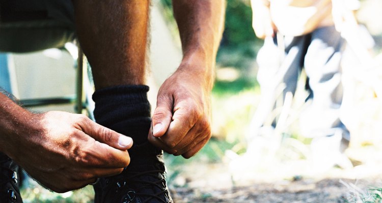 man tying the laces of his boots