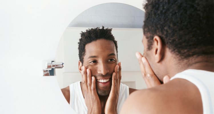 Man looking in wall mirror
