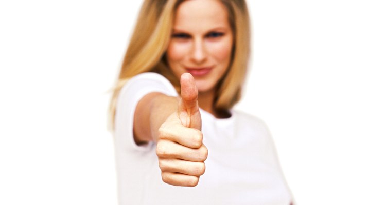 portrait of a young woman giving the thumbs up sign