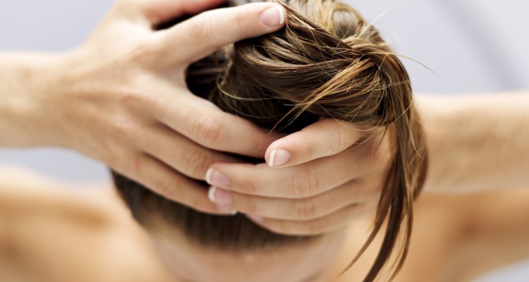 high angle view of a woman piling her hair up into a bun