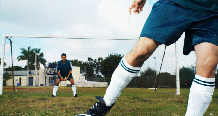 two young men (16-20) playing soccer