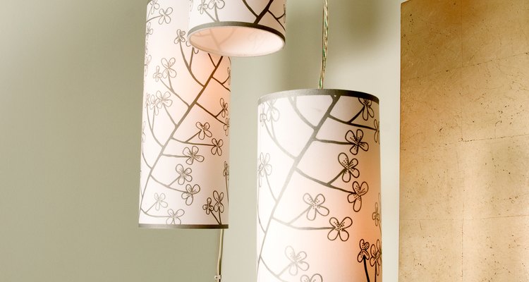Round paper lampshades with ribbon trim at the top and bottom edges.