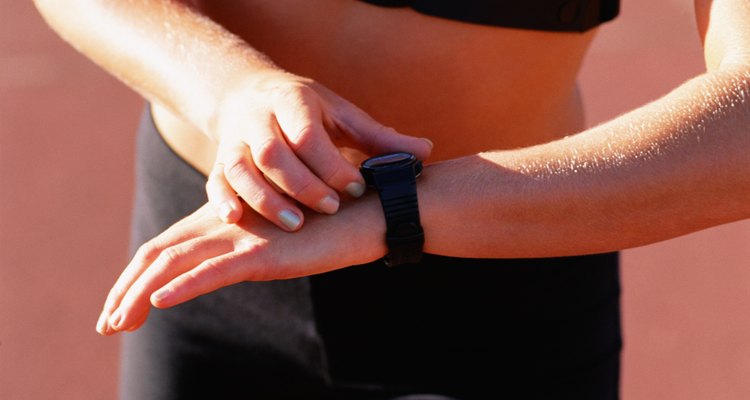 Woman looking at wristwatch in sports attire