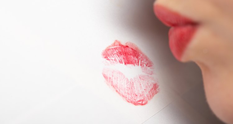 Woman sealing letter with a kiss