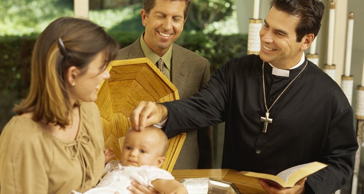 priest baptizing a baby boy