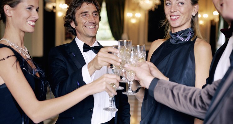 Adults wearing formal attire, toasting champagne glasses