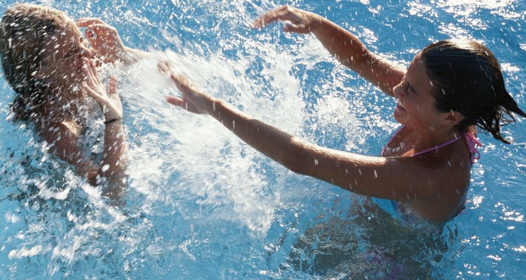 Two teenage girls (14-17) playing in water, elevated view