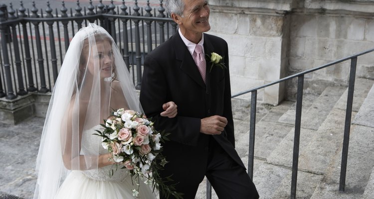 Father escorting bride up steps to church, smiling, elevated view
