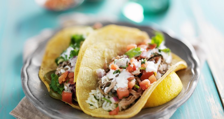 mexican authentic carnitas tacos with sour cream