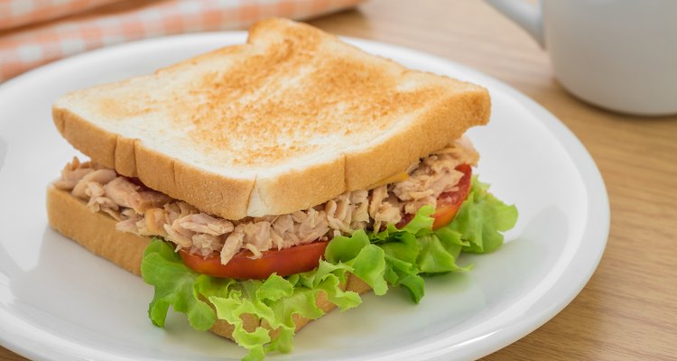 Tuna sandwich on plate and coffee cup