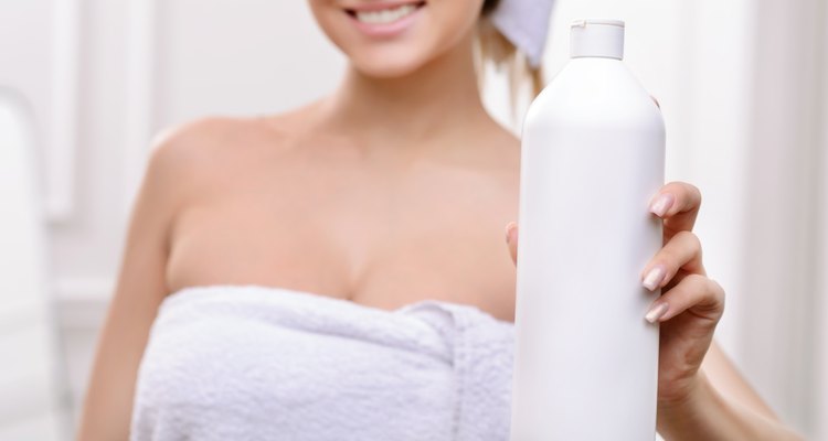 Positive girl holding bottle of shampoo