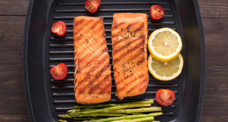 Grilled salmon cooked BBQ on a pan on wooden background