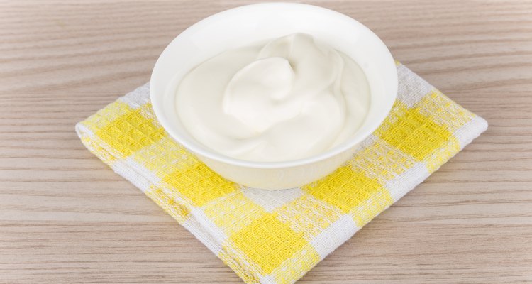 Sour cream in small bowl on yellow napkin