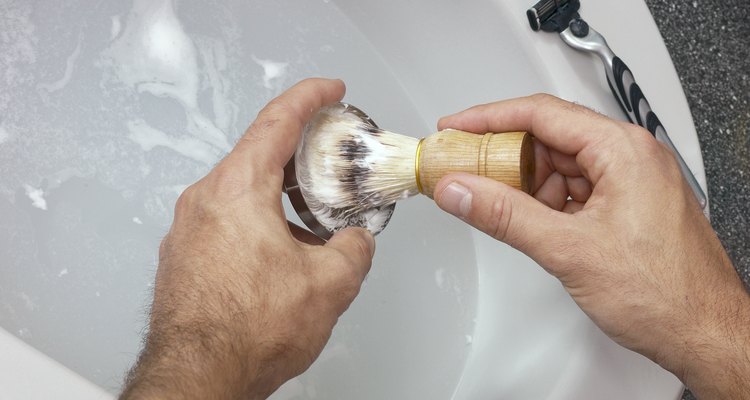 Hands holding shaving brush