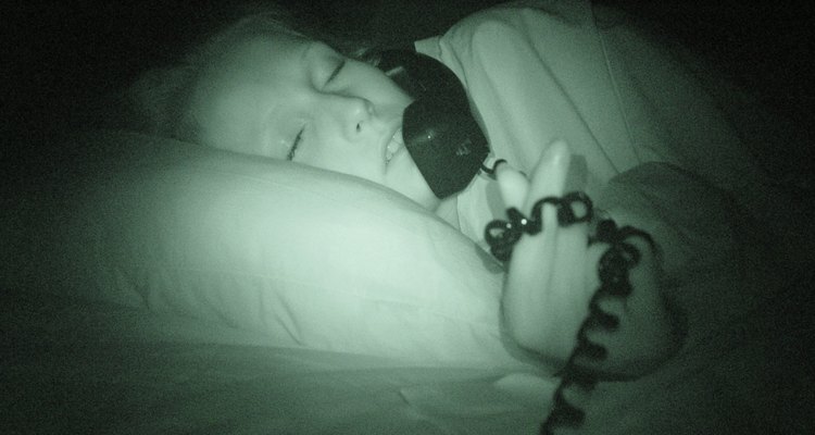 Woman in bed answering telephone