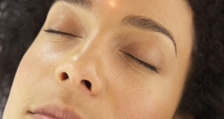 Woman receiving alternative therapy on face