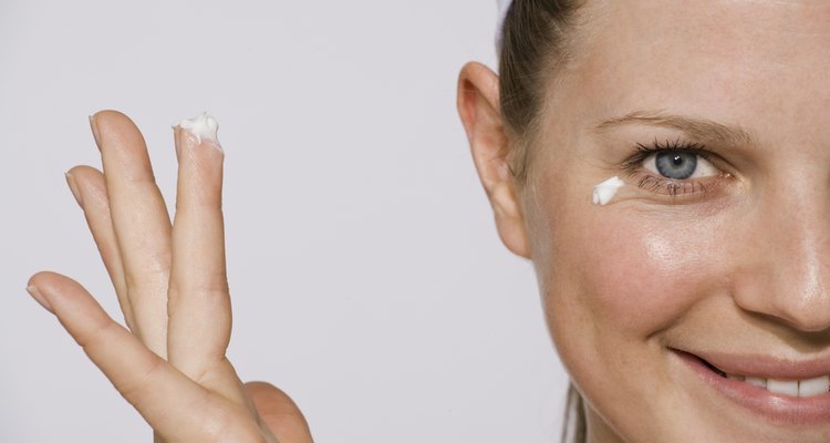 Woman applying eye cream