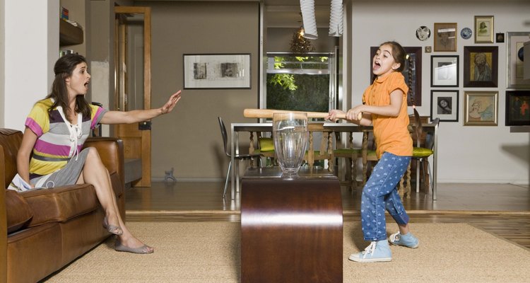 Mother scolding daughter with baseball bat