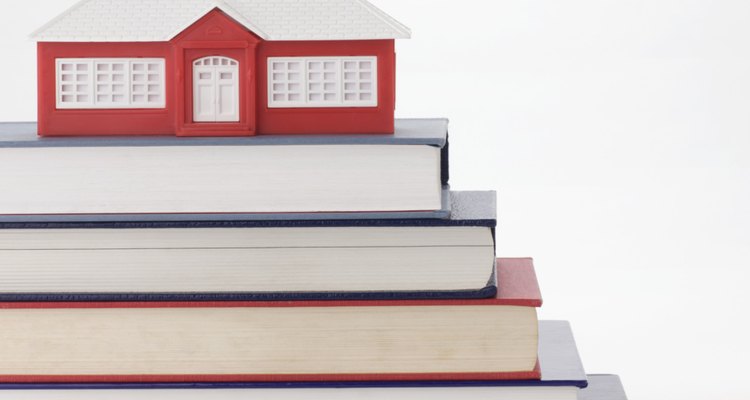 Stack of books and model schoolhouse