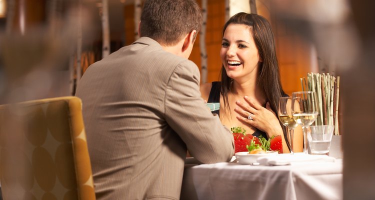 Woman receiving gift from man in restaurant