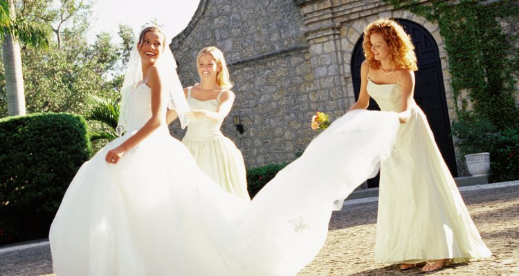 portrait of a bride a two bridesmaid outside a church