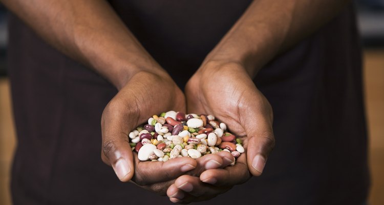 Man holding a variety of seeds