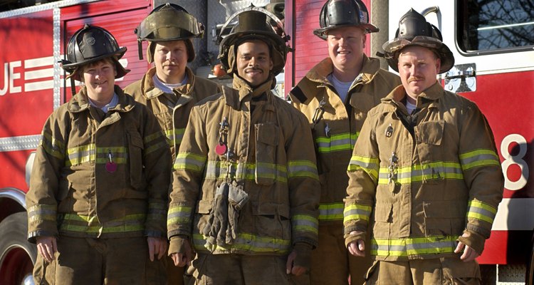 Firefighters standing near fire truck