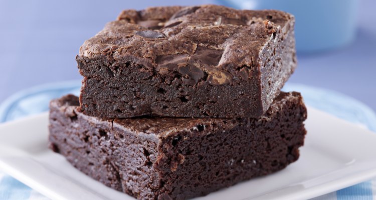 two brownies stacked on a plate.