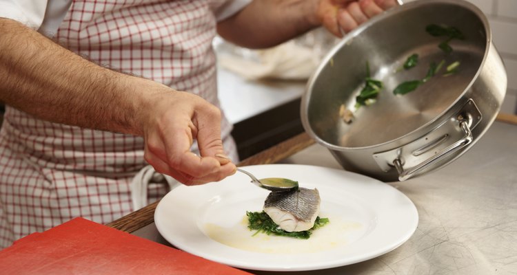 Chef is serving steamed seabass