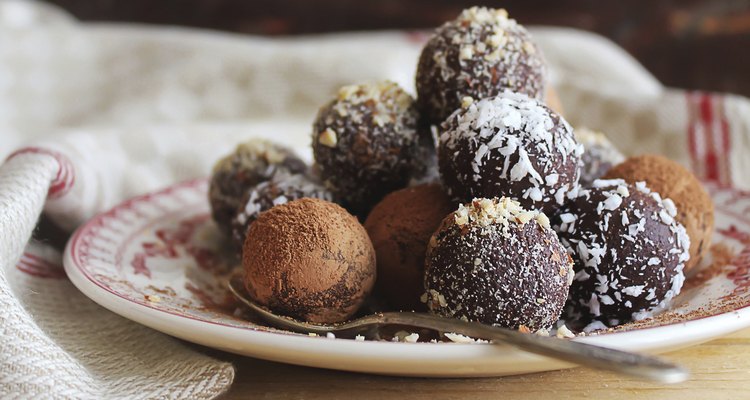 Homemade chocolate truffles with nuts, coconut and cocoa powder