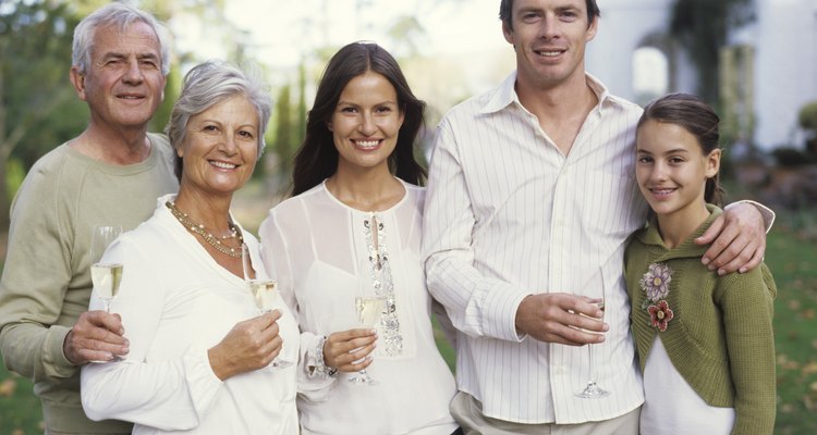 Family with teenage girl (12-14) holding champagne, portrait