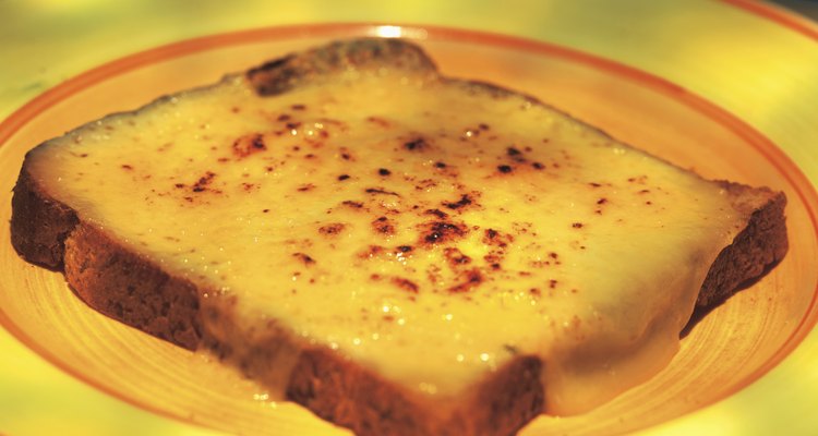 close-up of cheese melted on a slice of bread