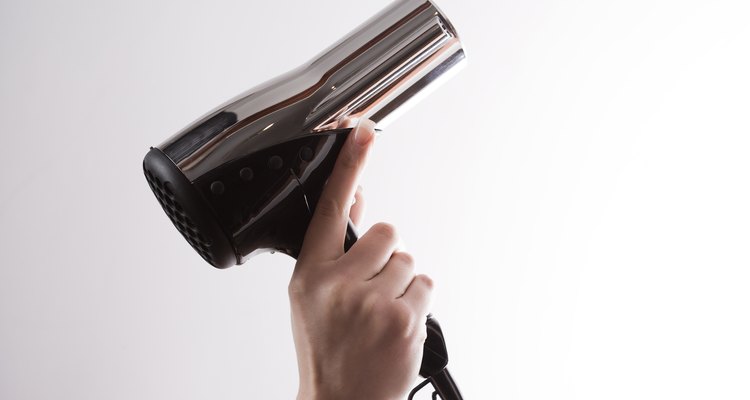 Woman holding hairdryer