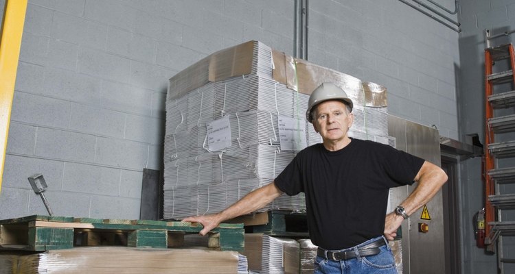 A worker preparing tertiary packaging in a warehouse.