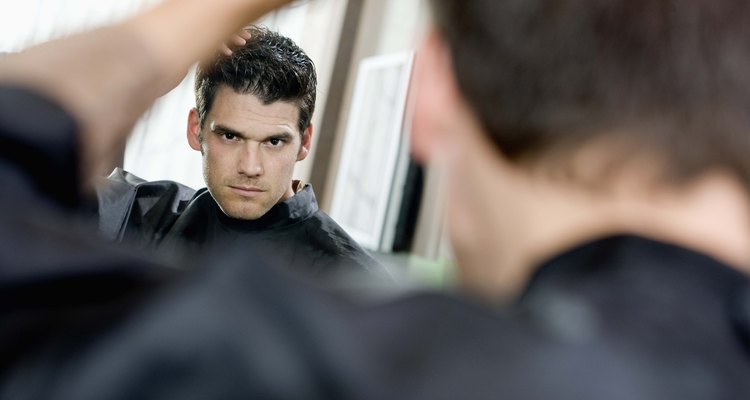 Man admiring hair in mirror