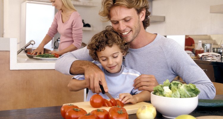 Father and son slicing vegetables