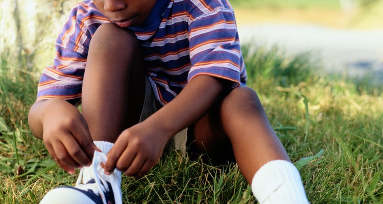 Boy Tying His Tennis Shoe