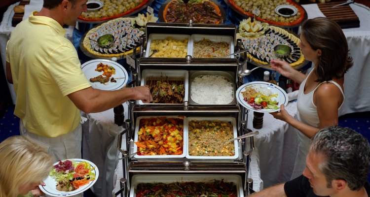 Two couples serving themselves at ship's buffet line in dining room