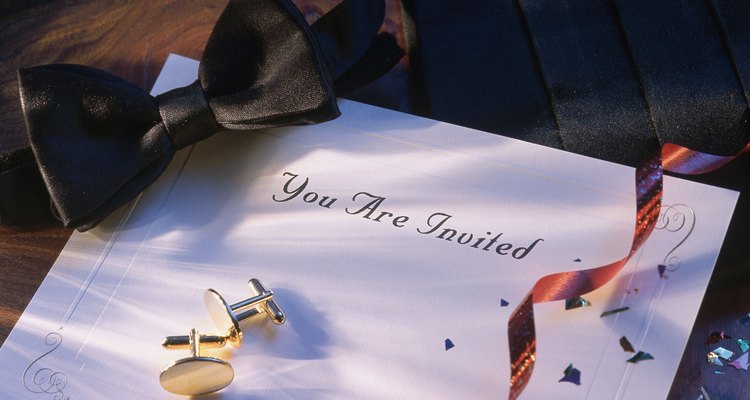 Bowtie and cuff links on top of invitation