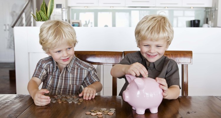 Twin boys and piggy bank