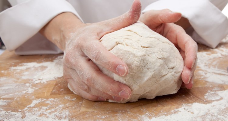 hands kneading bread dough