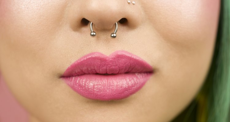 Lips of young woman wearing pink lipstick