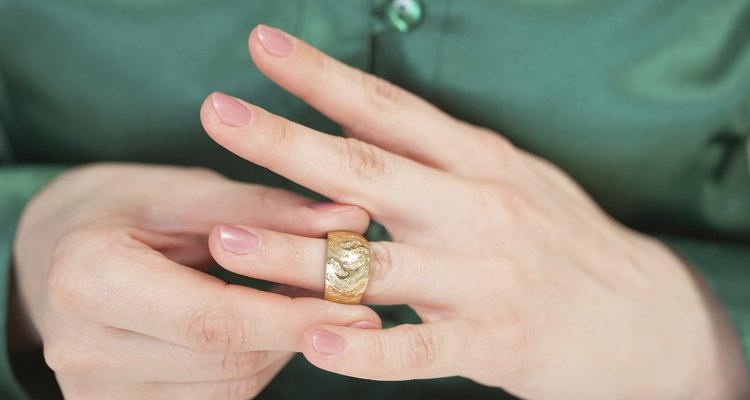 Woman tries on large gold ring