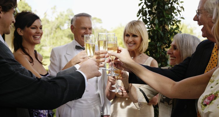 Bride and groom toasting with champagne and guests