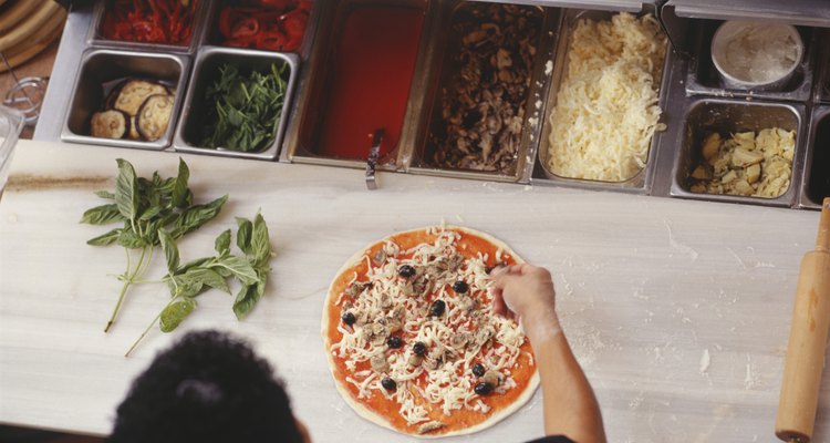 Chef making pizza on table, elevated view