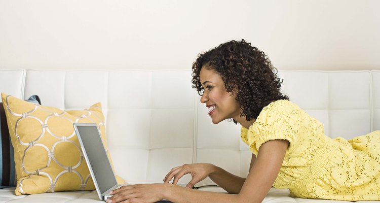 Woman with laptop on couch