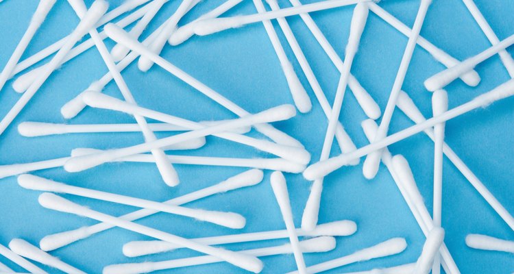Clean around the keys and other small spaces with cotton swabs.