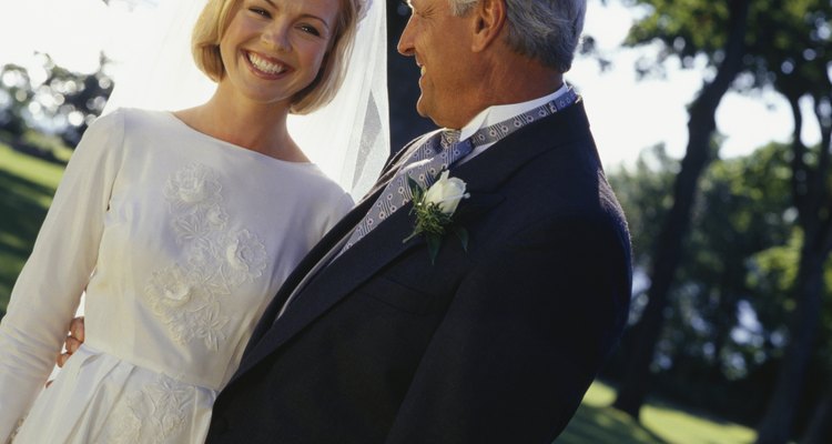 Bride and father in park, close-up