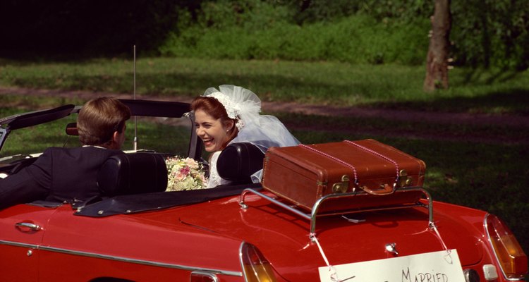 Newlyweds driving in convertible with 